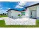 Single story home with white exterior, gray accents, and landscaping at 2743 Hopwood Rd, North Port, FL 34287