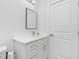 Simple bathroom with a single vanity, mirror, and white cabinetry at 2743 Hopwood Rd, North Port, FL 34287