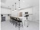 Modern kitchen with white cabinets, stainless steel appliances, and an island at 2743 Hopwood Rd, North Port, FL 34287