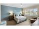 Serene bedroom with plush bedding, a ceiling fan and large windows at 2630 Tarpon Cove Dr # 212, Punta Gorda, FL 33950