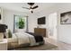 Bright bedroom with a ceiling fan, large window, and en-suite bathroom access at 5000 Palermo Dr, Punta Gorda, FL 33950