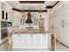 Luxury kitchen with large island, decorative range hood, and custom cabinetry at 5000 Palermo Dr, Punta Gorda, FL 33950