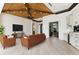 Open living space with a brown leather couch, built-in bar, and home office at 5000 Palermo Dr, Punta Gorda, FL 33950