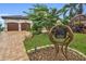 Home's exterior showcasing a two-car garage and unique mailbox design at 5000 Palermo Dr, Punta Gorda, FL 33950