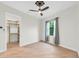 Spacious bedroom with ceiling fan, large window, and adjacent closet at 5000 Palermo Dr, Punta Gorda, FL 33950