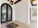 Elegant entryway with arched, ornate iron doors and light wood flooring at 5000 Palermo Dr, Punta Gorda, FL 33950
