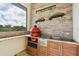 Outdoor kitchen with stainless steel appliances and granite countertops at 5000 Palermo Dr, Punta Gorda, FL 33950