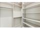 Bright walk-in closet with custom built-in shelving and rods at 5000 Palermo Dr, Punta Gorda, FL 33950