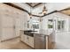 Island kitchen with copper farmhouse sink, white cabinetry, and granite countertop at 5000 Palermo Dr, Punta Gorda, FL 33950