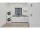 Bright laundry room with modern appliances and ample cabinet space at 5000 Palermo Dr, Punta Gorda, FL 33950