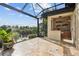 Covered outdoor kitchen with built-in grill and water views at 5000 Palermo Dr, Punta Gorda, FL 33950