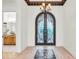 Elegant entryway with arched, ornate iron doors and a mosaic tile floor at 5000 Palermo Dr, Punta Gorda, FL 33950