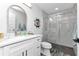 Modern bathroom features a glass-enclosed shower, marble countertops, and stylish nautical decor at 1425 Park Beach Cir # 127, Punta Gorda, FL 33950