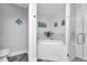 A bright bathroom with marble-style surfaces, a tub, and a glass-enclosed shower at 1425 Park Beach Cir # 127, Punta Gorda, FL 33950