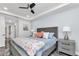 Stylish bedroom featuring a patterned bedspread, ceiling fan, and sleek gray nightstand at 1425 Park Beach Cir # 127, Punta Gorda, FL 33950