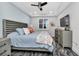 Serene bedroom with a ceiling fan, shuttered windows, stylish dressers, and luxurious wood-look floors at 1425 Park Beach Cir # 127, Punta Gorda, FL 33950