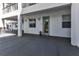 Exterior unit entrance features a modern glass door, large windows, and a neutral color scheme at 1425 Park Beach Cir # 127, Punta Gorda, FL 33950