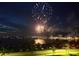 Scenic view of fireworks over the water, reflecting light onto the nearby buildings and parked cars at 1425 Park Beach Cir # 127, Punta Gorda, FL 33950