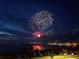 Beautiful fireworks display over the water, with cars and buildings visible on the shore at 1425 Park Beach Cir # 127, Punta Gorda, FL 33950