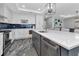 Kitchen with a large island, white countertops, stainless steel appliances, and dark backsplash at 1425 Park Beach Cir # 127, Punta Gorda, FL 33950