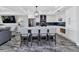 Bright open kitchen featuring an island with barstool seating, white cabinetry, and stainless steel appliances at 1425 Park Beach Cir # 127, Punta Gorda, FL 33950