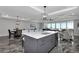 Kitchen and living space with island seating, a modern light fixture, and an open-concept design at 1425 Park Beach Cir # 127, Punta Gorda, FL 33950