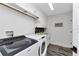 Well-lit laundry room with modern appliances, storage cabinets, and a sink at 1425 Park Beach Cir # 127, Punta Gorda, FL 33950