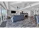 Open-concept living space with a modern kitchen, comfortable seating, and large windows with water views at 1425 Park Beach Cir # 127, Punta Gorda, FL 33950