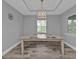 Dining room featuring wood-look tile, modern light fixture, and natural light from a window at 14516 San Domingo Blvd, Port Charlotte, FL 33981