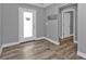 Entryway with wood-look tile flooring, neutral paint, and a bright front door at 14516 San Domingo Blvd, Port Charlotte, FL 33981