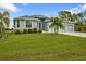 Charming single-story home featuring a three-car garage and lush green lawn at 14516 San Domingo Blvd, Port Charlotte, FL 33981