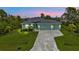 Charming single-story home featuring a three-car garage and well-manicured lawn at 14516 San Domingo Blvd, Port Charlotte, FL 33981