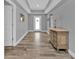 Welcoming foyer featuring tray ceilings, decorative console table, and wood-look tile at 14516 San Domingo Blvd, Port Charlotte, FL 33981