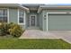 Inviting front entrance showcasing a well-kept garden and a charming exterior light fixture at 14516 San Domingo Blvd, Port Charlotte, FL 33981