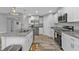 Beautiful kitchen featuring stainless appliances, granite countertops, island sink, and ample white cabinetry at 14516 San Domingo Blvd, Port Charlotte, FL 33981