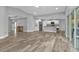 Spacious open-concept living area with wood-look tile flooring and plenty of natural light at 14516 San Domingo Blvd, Port Charlotte, FL 33981