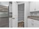 Walk-in pantry featuring wire shelving, granite countertops, and white cabinetry at 14516 San Domingo Blvd, Port Charlotte, FL 33981