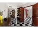 Bright hallway with built-in bookcase and checkerboard floor at 4460 Northshore Dr, Punta Gorda, FL 33980