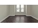 Spacious bedroom with dark hardwood floors and large windows at 95 Vivante Blvd # 9542, Punta Gorda, FL 33950