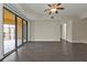 Bright living room with dark laminate floors and access to a private balcony at 95 Vivante Blvd # 9542, Punta Gorda, FL 33950