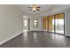 Open living room with dark floors, a ceiling fan and views to kitchen at 95 Vivante Blvd # 9542, Punta Gorda, FL 33950