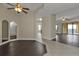 Bright living room with dark wood floors, ceiling fan and access to balcony at 95 Vivante Blvd # 9542, Punta Gorda, FL 33950