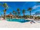 Inviting pool area with palm trees and plenty of lounge chairs at 95 Vivante Blvd # 9542, Punta Gorda, FL 33950