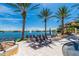 Relaxing pool deck with lounge chairs and tranquil lake view at 95 Vivante Blvd # 9542, Punta Gorda, FL 33950
