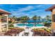 Resort-style pool with palm trees, lounge chairs, and surrounding buildings at 95 Vivante Blvd # 9542, Punta Gorda, FL 33950