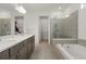 Spa-like bathroom with double vanity, walk-in shower, and a large soaking tub at 10213 Beach Dune Dr, Englewood, FL 34223