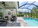 Covered patio, refreshing pool, and outdoor seating at 10213 Beach Dune Dr, Englewood, FL 34223