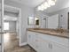 Double vanity bathroom with granite countertops and white cabinets at 14516 San Domingo Blvd, Port Charlotte, FL 33981