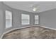 Charming bedroom with wood-look floors, a ceiling fan, and multiple windows at 14516 San Domingo Blvd, Port Charlotte, FL 33981