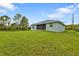 House with large backyard and grassy lawn at 14516 San Domingo Blvd, Port Charlotte, FL 33981